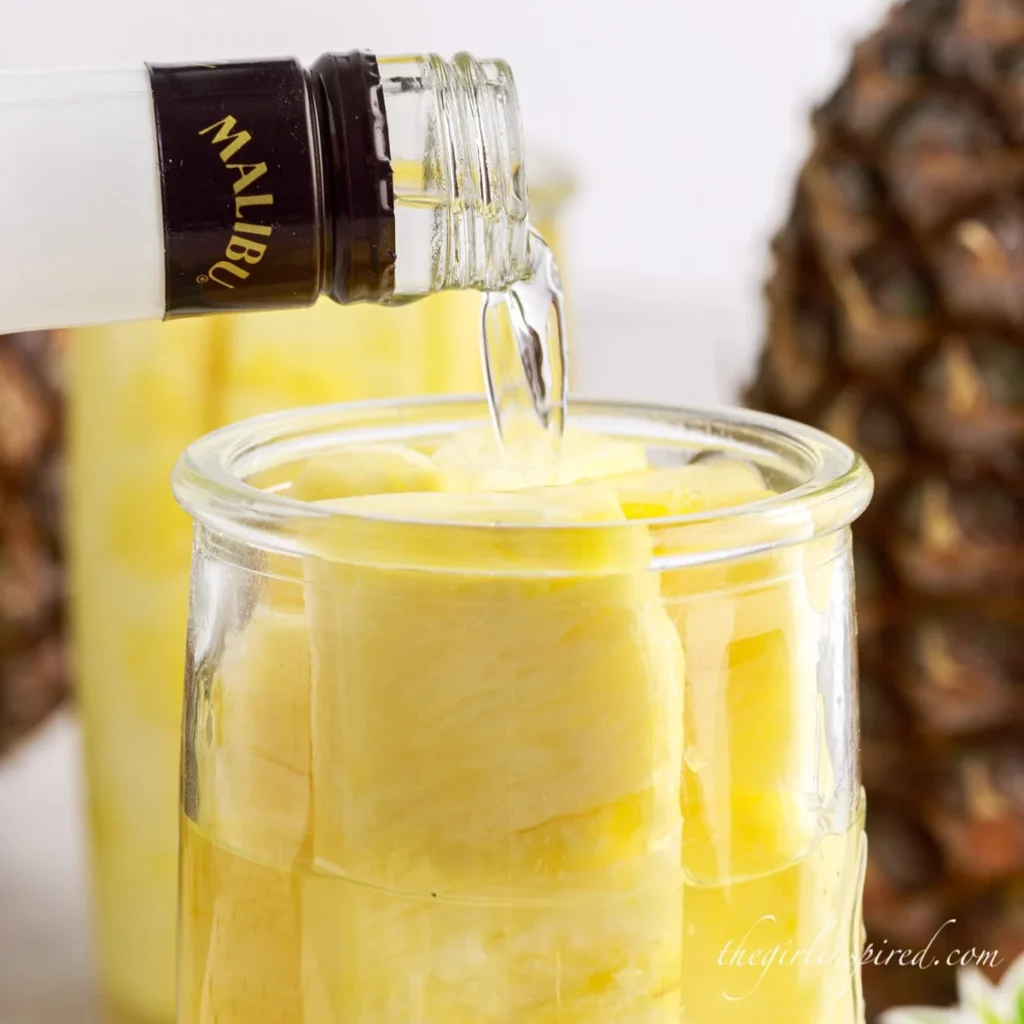 Pouring the moonshine in a jar - making pineapple moonshine