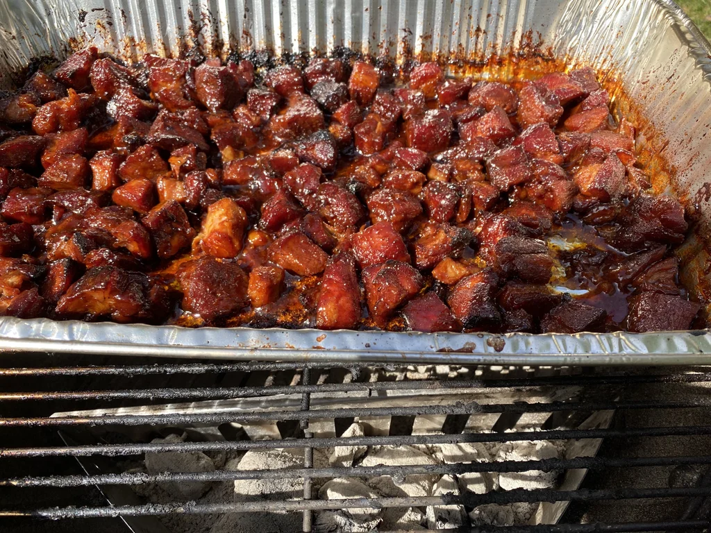 Return foil pan and the sauced-up cubes to the smoker