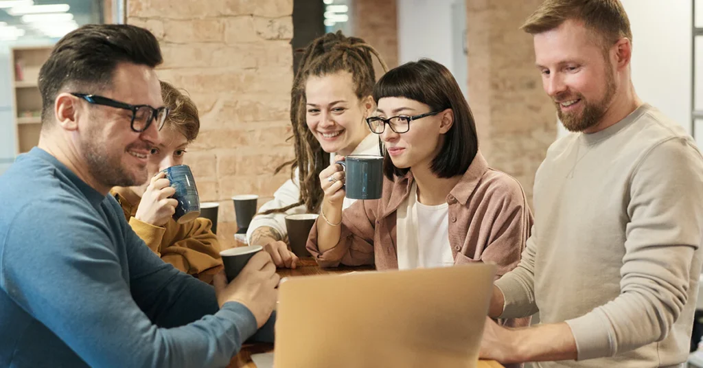 Having coffee and gossiping with co-workers