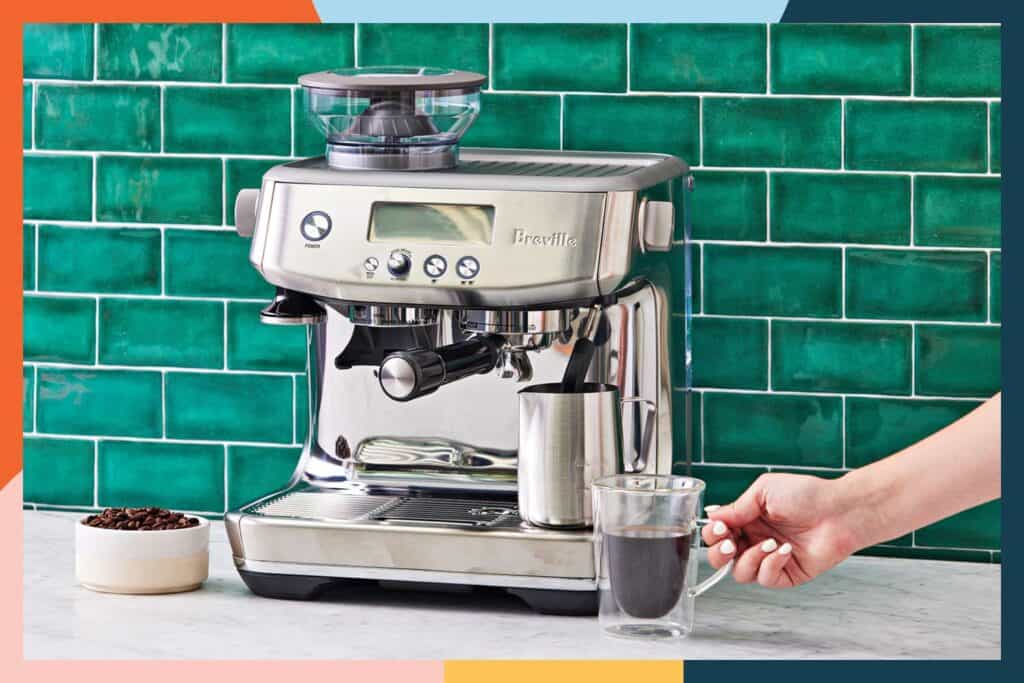 Coffee maker with grinder ,a cup of coffee and beans