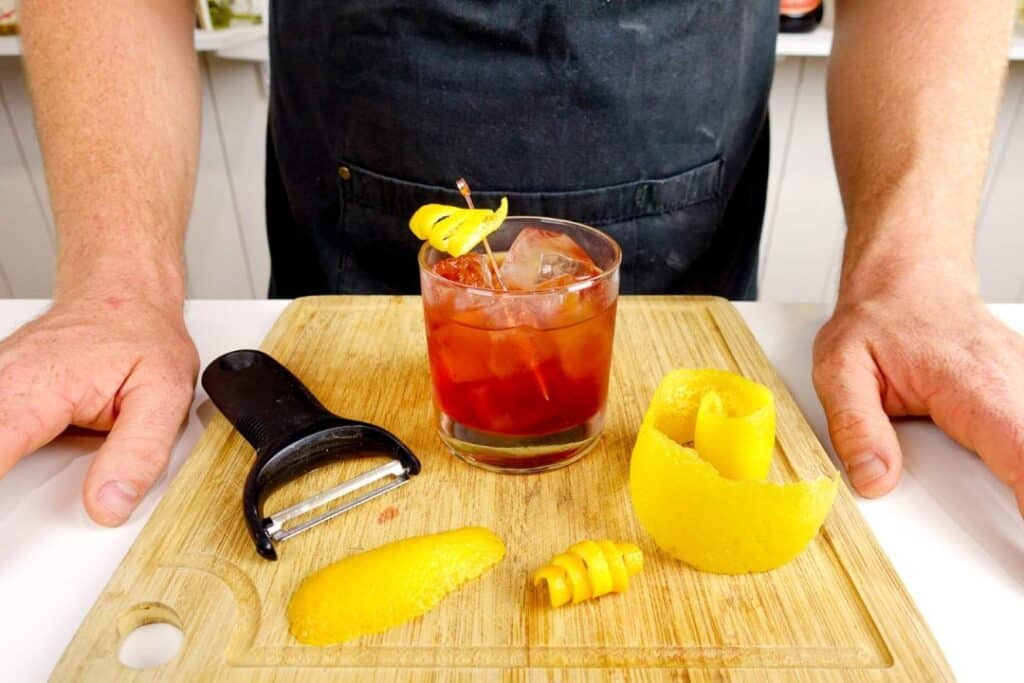 Prepare and putting garnish in bourbon mixing