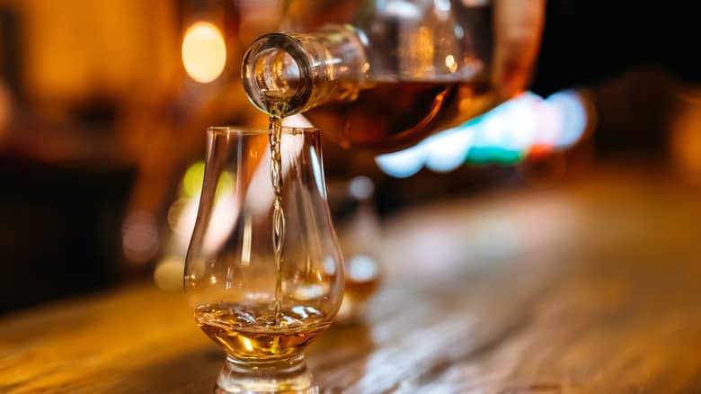 Pouring whiskey in glass